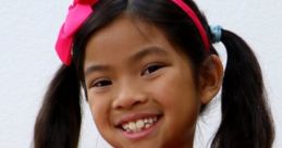Smiling girl in pink sequined top and headband, embodying the vibrant spirit of Emma's toys and colors 2020 theme.