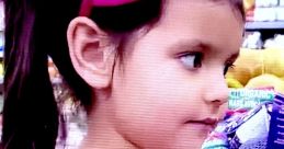 Little girl with pigtails and a pink bow, smiling in a vibrant, colorful store, reflecting the joy of Ellie toys & colors 2021.