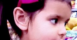 Young girl with a pink bow and shirt, showcasing vibrant engagement with Ellie Toys & Colors products in a playful setting.