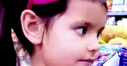 Young girl in pink shirt with bow, exploring colorful aisle, embodying the fun of Ellie Toys and Colors.