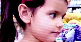 Young girl in a pink shirt with a bow, showcasing colors and toys during a playful moment, inspired by Ellie adventures.