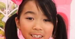 Lucy smiles brightly in a pink outfit featuring sequins, embodying the cheerful spirit of "Toys And Colors" Season 1.