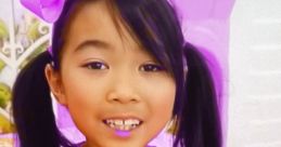 Girl in a sparkly purple outfit with a bow, smiling during a Lucy Toys and Colors playdate adventure. Fun and colorful theme!