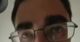Close-up of a man with glasses peering through a doorbell camera, reminiscent of Harry Dresden's "Doorbell Chud" scene.