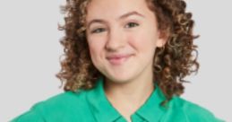 Young girl with curly hair wearing a green button-up shirt, smiling happily, representing a friendly vibe like Charle from Sesame Street.