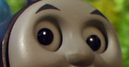 Happy smiling face of Thomas, the iconic blue engine from Thomas & Friends, set against a vibrant green background.