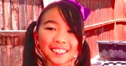 Lucy smiles brightly while playing in her purple sequined outfit during a fun adventure with Toys and Colors.