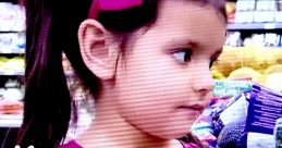 Young girl with a pink bow, wearing a pink shirt, curiously looking around a colorful toy aisle in a store.