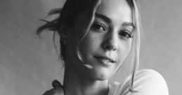 Chloe Lang exudes elegance in a casual outfit, showcasing her beauty and confidence in a captivating black-and-white portrait.