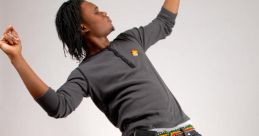 Young man dancing energetically, showcasing moves inspired by Yeahhhhhhhhh Dancehall culture, in stylish casual attire.