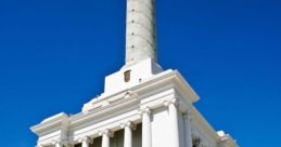 Monument in the Dominican Republic featuring classical architecture and a tall column against a clear blue sky.