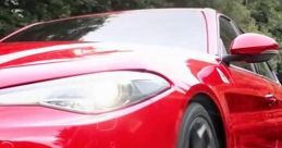Sleek red Alfa Romeo sports car in motion, showcasing its dynamic design and powerful stance on the road.