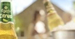 Carlsberg Citrus Lager bottle in a sunny outdoor setting, reflecting freshness and vibrant flavors for a perfect summer drink.