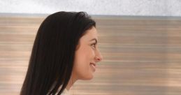 Woman smiling and extending a hand, conveying a warm greeting in a professional setting with a modern background.