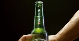 Hand gripping a Heineken bottle, promoting a Halloween celebration with the tagline, "Enjoy the scariest night of the year.