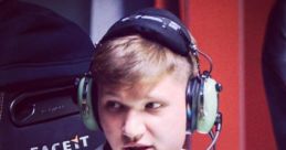 S1mple focused at his gaming station, wearing headphones and showcasing determination in esports competition.