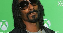 Snoop Dogg posing confidently next to Xbox branding, showcasing his signature style and charisma, a memorable celebrity moment.