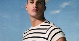 Stylish model in a sailor outfit promotes Jean Paul Gaultier's Le Male cologne against a vibrant blue background.