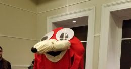 Red character costume referencing "De Way," featuring large expressive eyes and playful design in a convention setting.