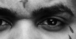 Close-up of a man with distinctive tattoos, capturing a serious expression, highlighting urban style and emotion.
