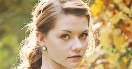 Wendy Darling-inspired portrait of a young woman in a vintage dress, surrounded by autumn leaves and soft lighting.