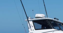 Sport fishing boat cruising smoothly over clear blue waters with fishing rods mounted, showcasing its sleek design.