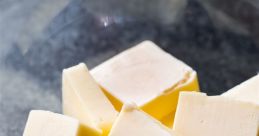 Fresh, creamy butter cubes in a glass bowl, perfect for cooking and baking. Essential ingredient for rich flavor.