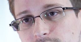 Close-up of Edward Snowden, known for his NSA whistleblowing, highlighting his glasses and thoughtful expression.