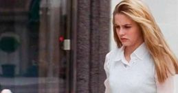Cher Horowitz walks past Tiffany & Co., showcasing her iconic style in "Clueless" with a chic outfit and confident demeanor.
