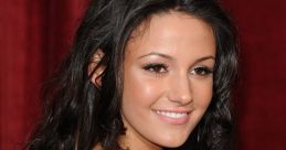 Smiling woman with long dark hair, wearing a strapless dress, posing against a rich red backdrop at a glamorous event.