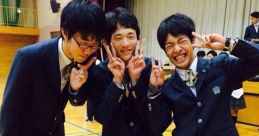 Three male students in skirts pose playfully in a school gym, showcasing Japanese school culture with vibrant energy.