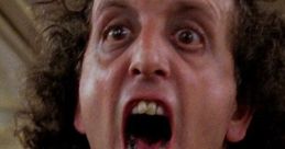 Intense close-up of a man screaming, embodying the spooky energy of "The Ghost Guy" in a classic horror scene.