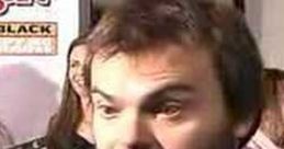 Jack Black speaking at a red carpet event, engaging with fans and media, showcasing his vibrant personality and charisma.