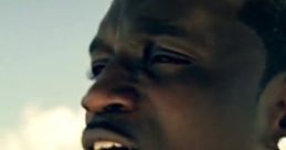 Akon performing passionately against a scenic ocean backdrop, showcasing his signature style and charisma.