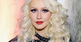 Christina Aguilera showcases glamorous style with long blonde curls and bold red lips at a recent event.