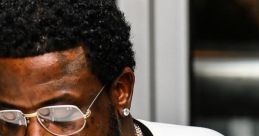 Gucci Mane showcasing his signature style with stylish glasses and layered jewelry, exuding confidence and charisma.