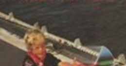 A young child joyfully plays with a colorful toy, capturing the spirit of creativity associated with Jefferson Starship's music.
