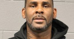 R. Kelly's mugshot featuring him in a black hoodie against a gray background, reflecting his legal troubles.