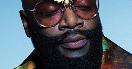 Rick Ross showcases his signature style with bold sunglasses, flashy jewelry, and an artistic jacket, epitomizing luxury.