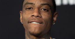 Soulja Boy showcasing his signature style with gold chains and a bold graphic tee, exuding confidence and charisma.