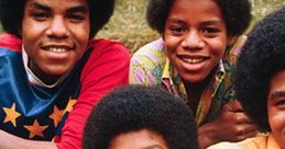 The Jackson 5 pose together with big afros, showcasing their iconic style and youthful charm during the 1970s.