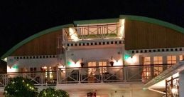 Charming exterior of Club House 1 at night, showcasing its welcoming atmosphere and beautifully lit entrance.