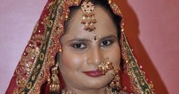 Traditional Indian bride adorned in intricate red bridal wear and elaborate jewelry, showcasing cultural richness and beauty.