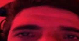 Close-up shot of a person illuminated in red light, expressing intense emotions in a casual setting. Tense1983 2020 vibe.