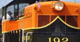 Colorful diesel train number 192 with distinctive design, showcasing classic locomotive features on vibrant tracks.