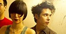 Stylish group with unique haircuts in a dimly lit hallway, capturing the essence of alternative music culture.