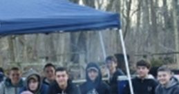Campfire gathering at NYLT 11, featuring youth engaging in teamwork and camaraderie in a forest setting.