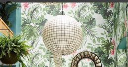 Stylish interior with tropical wallpaper, mirrors, and elegant dining setup, perfect for My Random Board inspiration.
