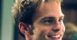 Stifler's iconic look with a smile, wearing a vibrant blue patterned shirt, capturing his charismatic personality.