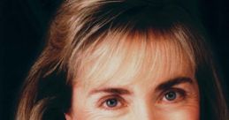 Hillary Clinton smiles warmly, showcasing her signature style with elegant hair and attire, representing political leadership.